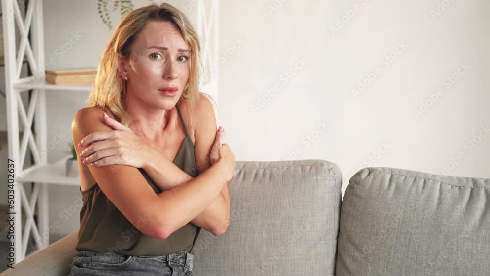 Shocked situation. Scared woman. Fear frustration. Disbelief frighten pretty lady being worried sitting sofa in light room interior copy space. Shocked situation. Scared woman. Fear frustration. Disbelief frighten pretty lady being worried sitting sofa in light room interior copy space.