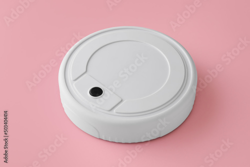 Modern robot vacuum cleaner on pink background