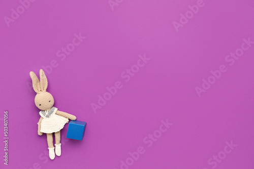 Toy with cube on purple bac...