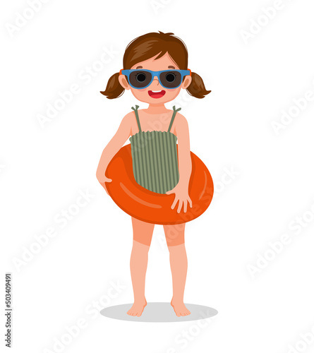 cute little girl with swimsuit and sun glasses holding inflatable rubber ring having fun on summer time