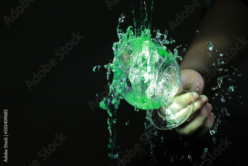 Green water splash in glass