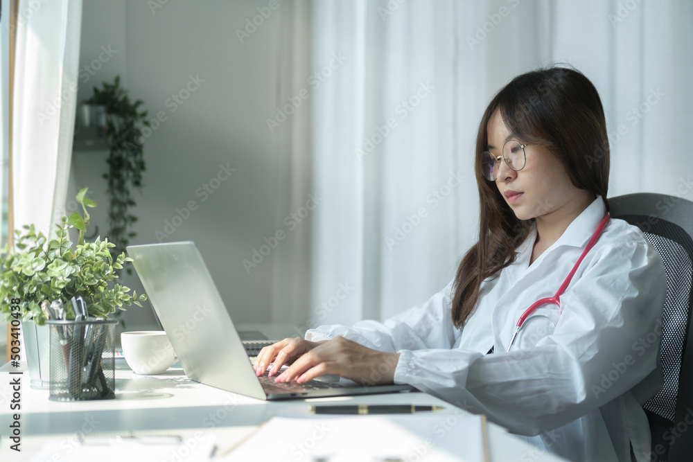 Confident female doctor in white coat in medical office. Healthcare and medical concept.. Confident female doctor in white coat in medical office. Healthcare and medical concept..