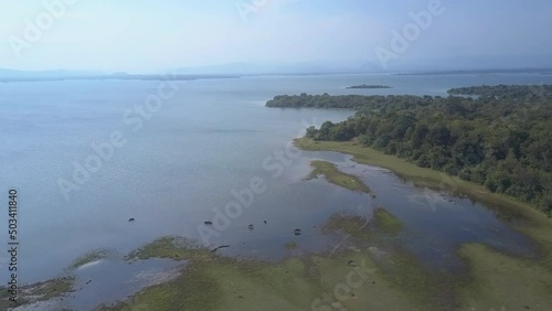 Wallpaper Mural Lake with blue water near lush forest in Udawalawe Safari against distant mountains in fog. Sunny morning in natural reserve of Sri Lanka aerial view Torontodigital.ca