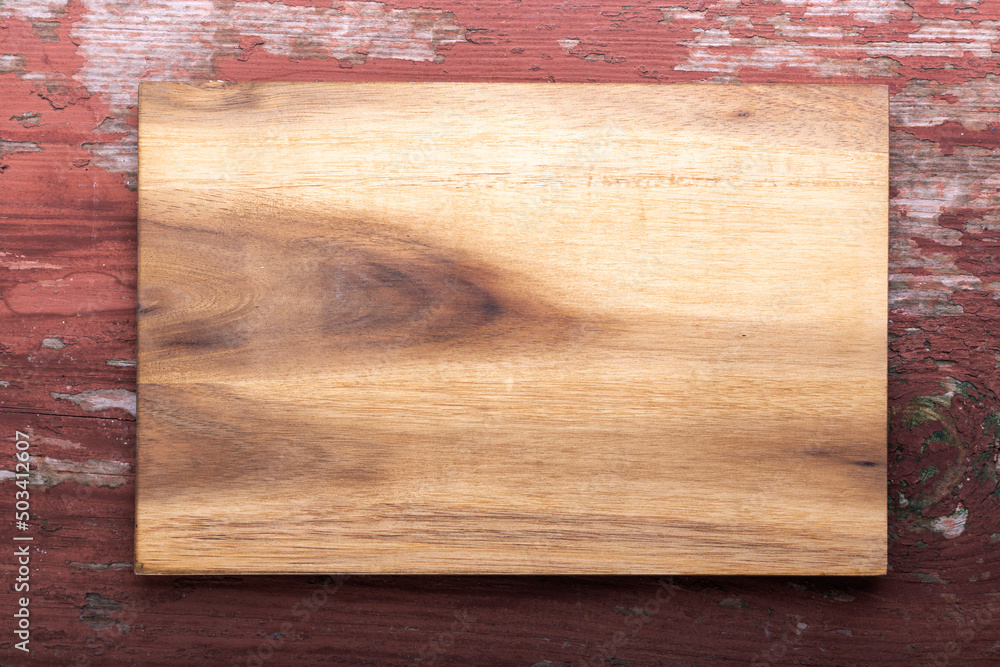 Empty cutting board on a wooden background. Top view. Empty cutting board on a wooden background. Top view.
