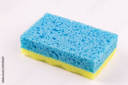 Yellow- blue sponge for washing dishes close-up