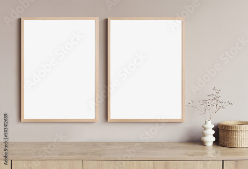 Blank frame mockup in modern interior design with vase and trendy plants on empty white wall background, Two vertical templates for paintings, photos or posters. Artwork mock-up