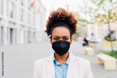 Businesswoman wearing protective face mask for smog photo