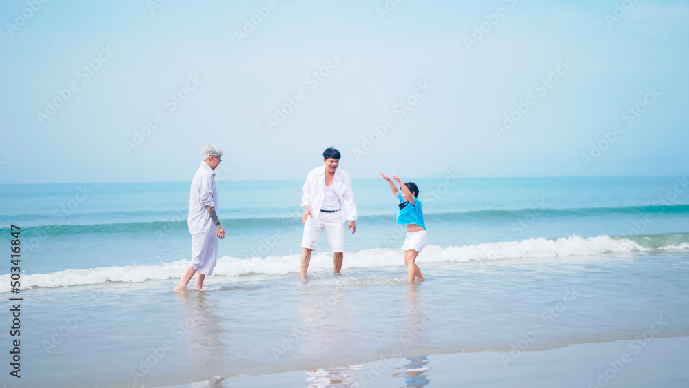 Grandfather and grandmother are playing with their little granddaughter on the beach. Grandfather and grandmother are playing with their little granddaughter on the beach.