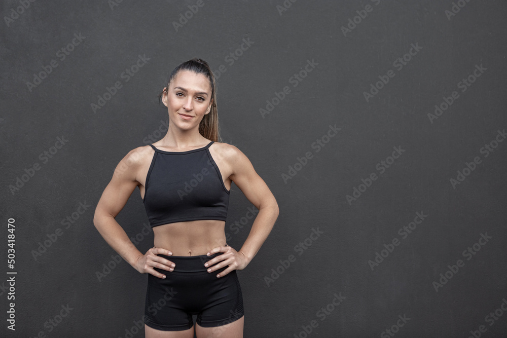 Confident female athlete with hands on waist Confident female athlete with hands on waist