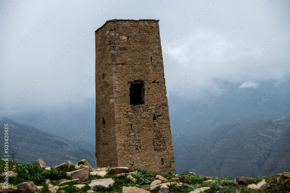 an old dilapidated fortress in the mountains of Dagestan against the backdrop of stunning views of mountains and gorges