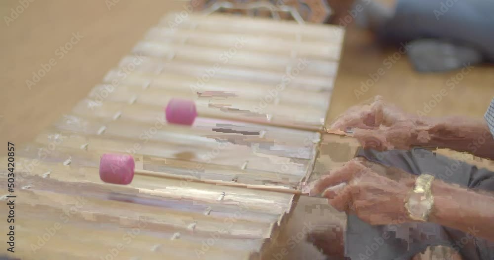 Thai musical instruments. The alto xylophone make a soft sound accompaniment to the rhythm of the music. ( close up hands ) Thai musical instruments. The alto xylophone make a soft sound accompaniment to the rhythm of the music. ( close up hands )