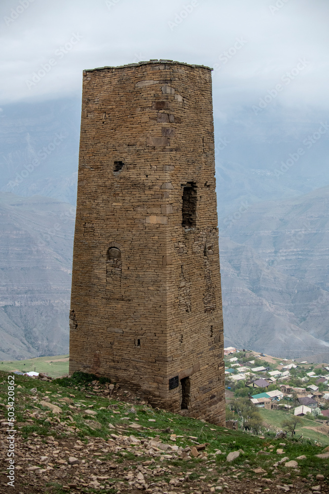 an old dilapidated fortress in the mountains of Dagestan against the backdrop of stunning views of mountains and gorges