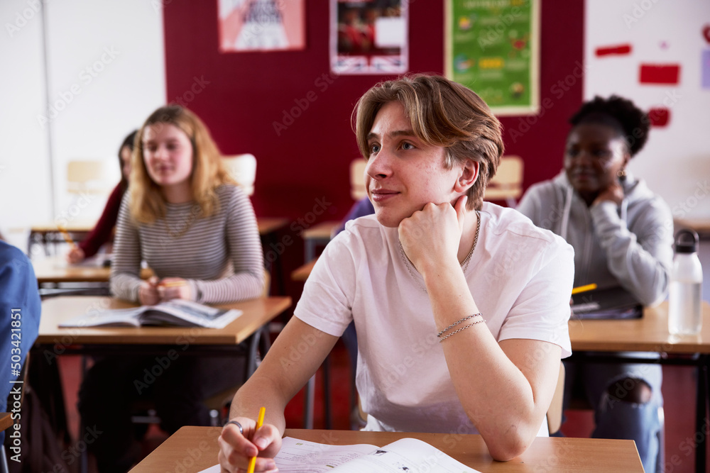 Teenage boy sitting in classroom Teenage boy sitting in classroom