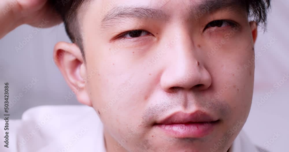 Close up Asian man and healthy good hair looking to the camera and spoiling himself by tidying his hair. Slow motion. Close up Asian man and healthy good hair looking to the camera and spoiling himself by tidying his hair. Slow motion.