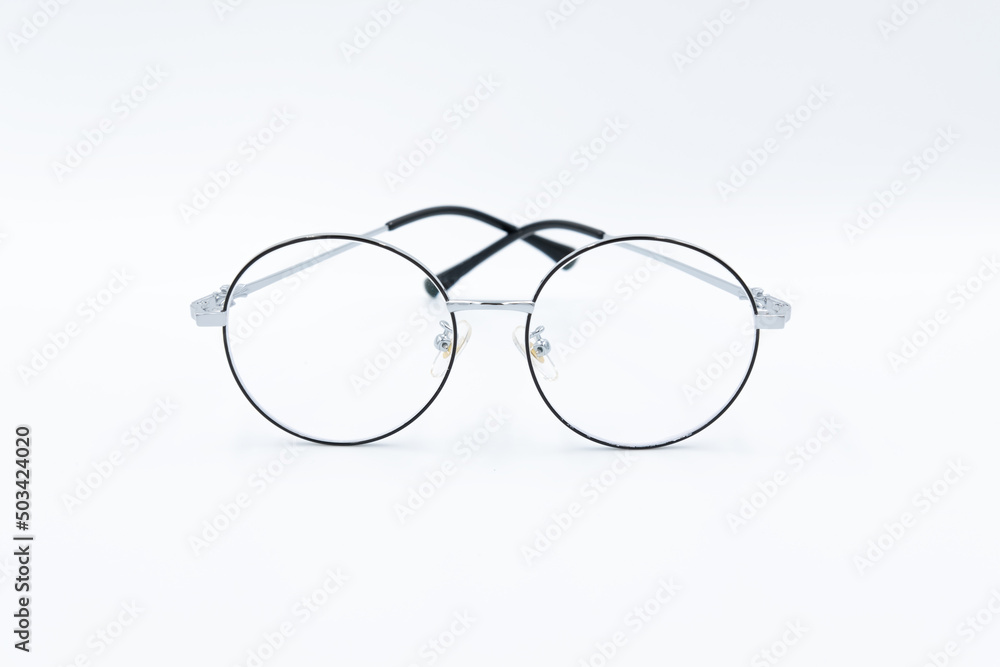 Isolated white background, Selective focus round eyeglasses with silver rim. Isolated white background, Selective focus round eyeglasses with silver rim.