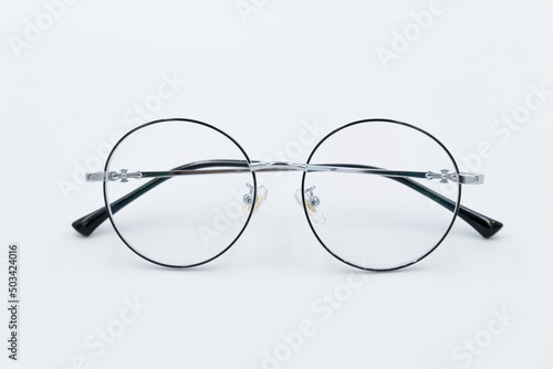Selective focus round eyeglasses with silver rim. Isolated white background.