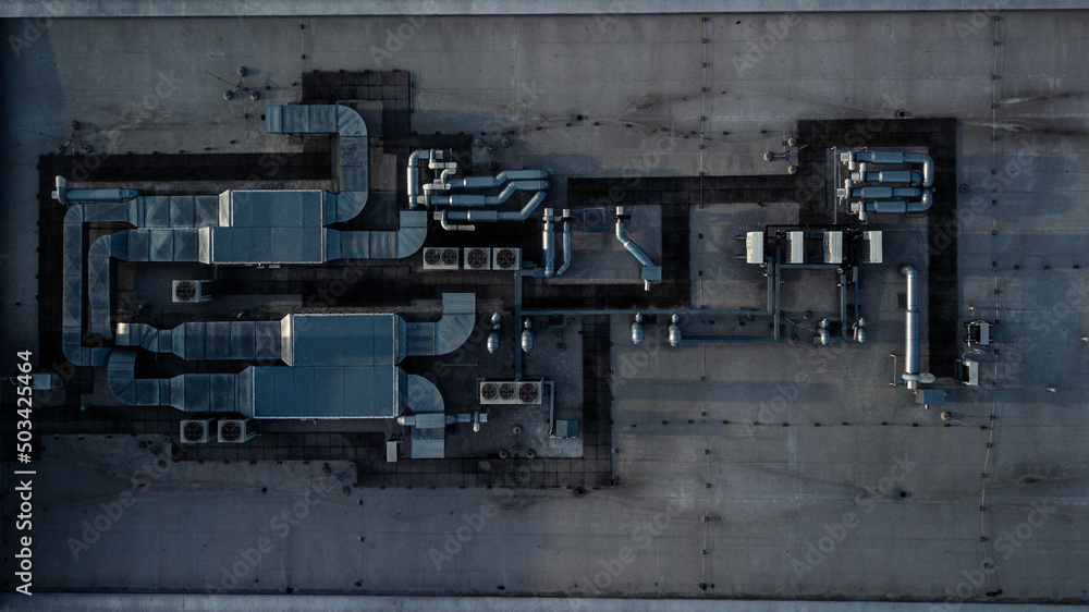 Air conditioning equipment atop a modern building - aerial/drone view of the roof with all the necessary installations