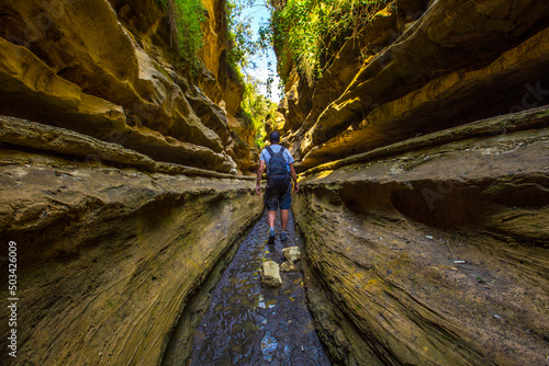 Slika na platnu A tourist man in the beautiful canyon of Hell's Gate Park in Naivasha, Kenya