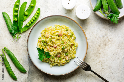 Italian, Venetian rice and spring green pea. Risi e bisi.  Spring dish made with Vialone nano rice, green peas, parsley and bacon. Ingredients. Horizontal image, copy space. photo
