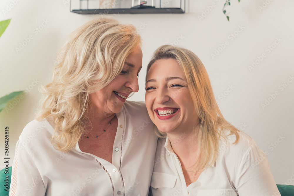 Happy mature mother and grown-up adult daughter smiling together, portrait. High quality photo Happy mature mother and grown-up adult daughter smiling together, portrait. High quality photo