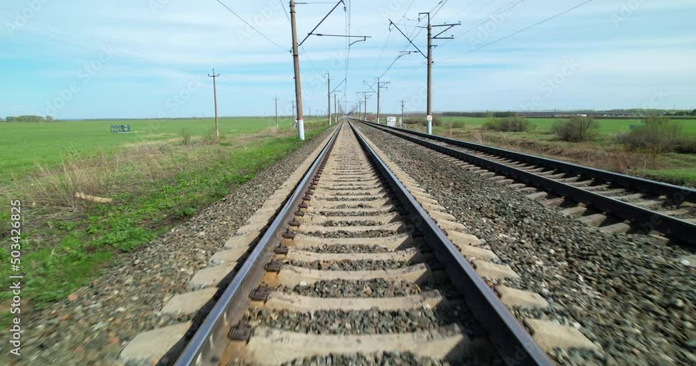 Railway track view in motion. Rails for trains. Railway lines in sunny weather. Railway track view in motion. Rails for trains. Railway lines in sunny weather.