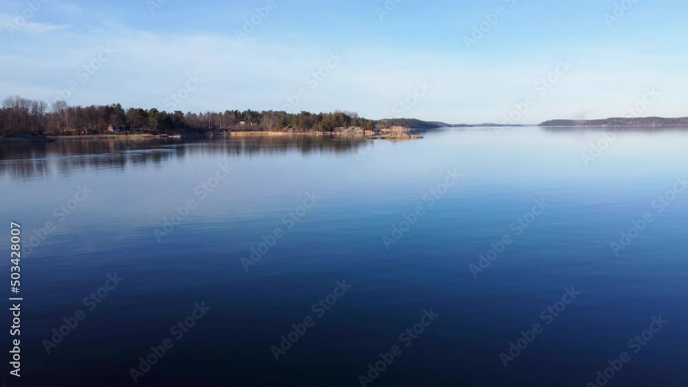 Low slow forward aerial of still water and islands in the Baltic sea Low slow forward aerial of still water and islands in the Baltic sea