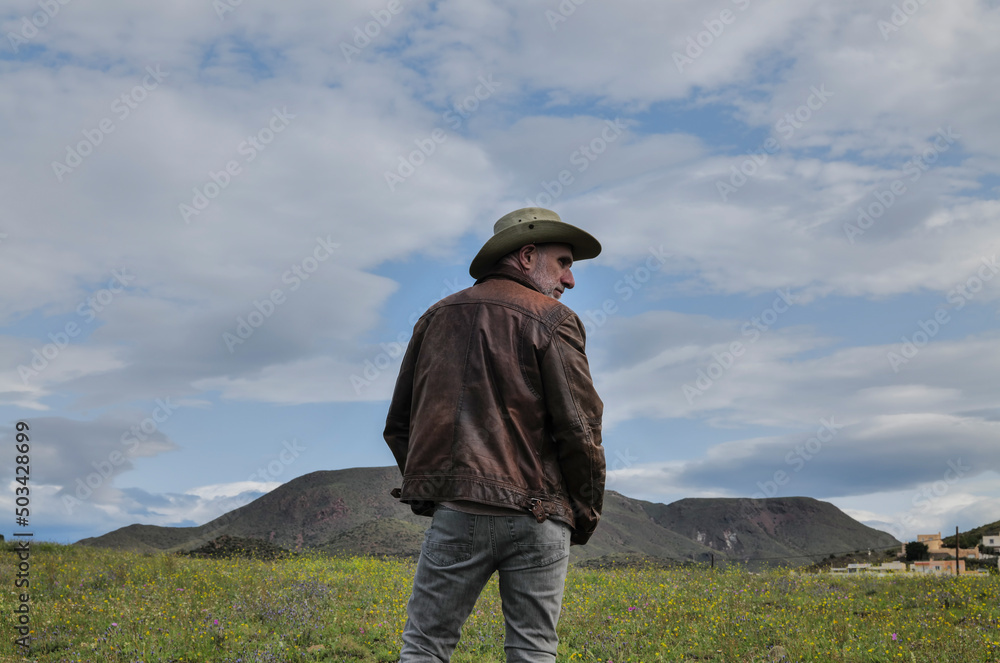 Portrait of adult man in cowboy hat on field Portrait of adult man in cowboy hat on field