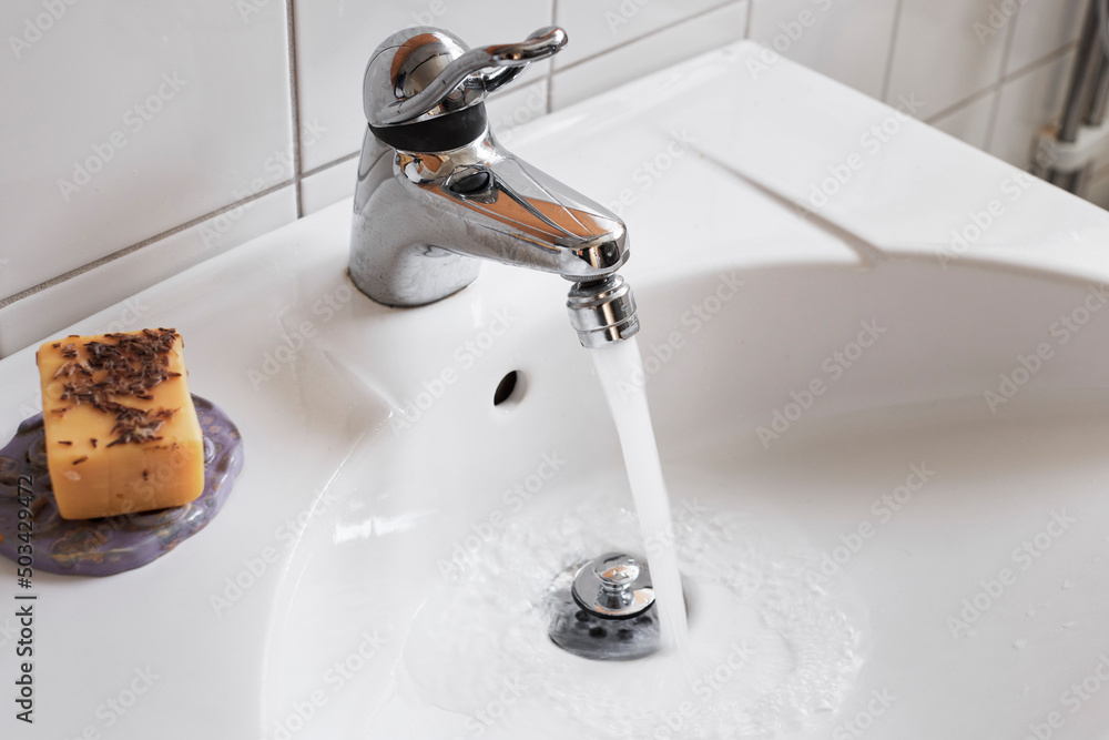 Water running from bathroom tap Water running from bathroom tap