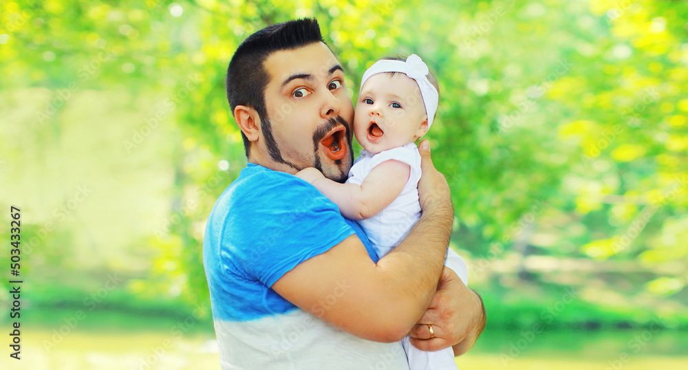 Portrait of happy funny surprised father holding and playing with her baby in summer park Portrait of happy funny surprised father holding and playing with her baby in summer park