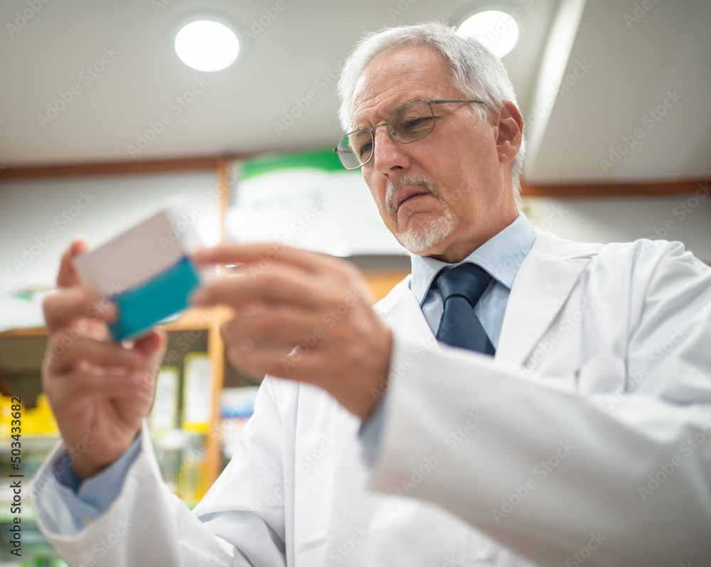 Pharmacist looking at a medicine Pharmacist looking at a medicine