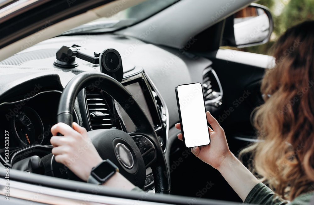 Woman using phone in car