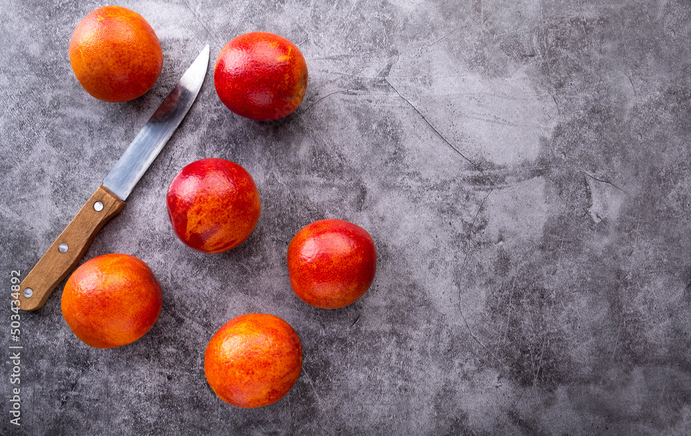 Red oranges with a knife. Top view, text space Red oranges with a knife. Top view, text space