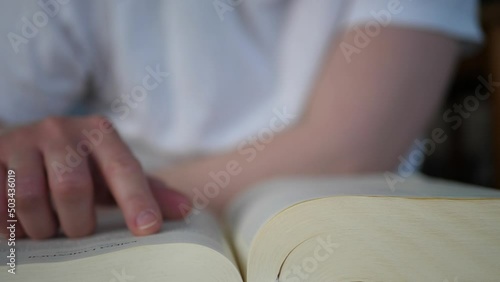 Woman flipping through pages of the bible