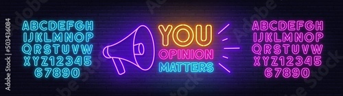 Your opinion matters with a megaphone neon sign on brick wall background.