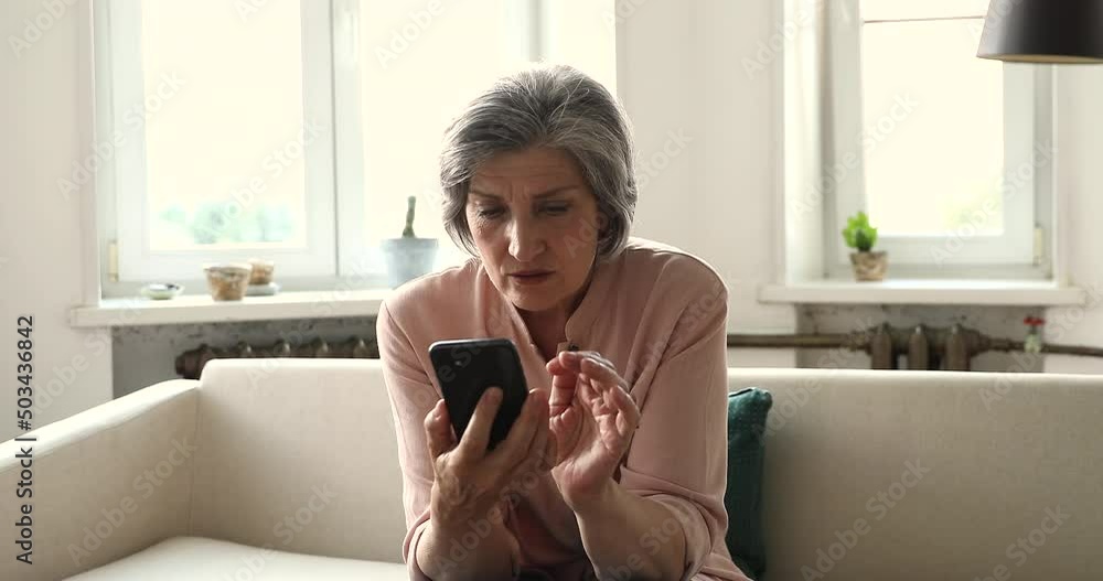 Shocked excited emotional mature Latin woman look on phone screen read unbelievable great news astonished of winning jackpot prize in web lottery. Amazed old lady get unexpected victory at online game Shocked excited emotional mature Latin woman look on phone screen read unbelievable great news astonished of winning jackpot prize in web lottery. Amazed old lady get unexpected victory at online game
