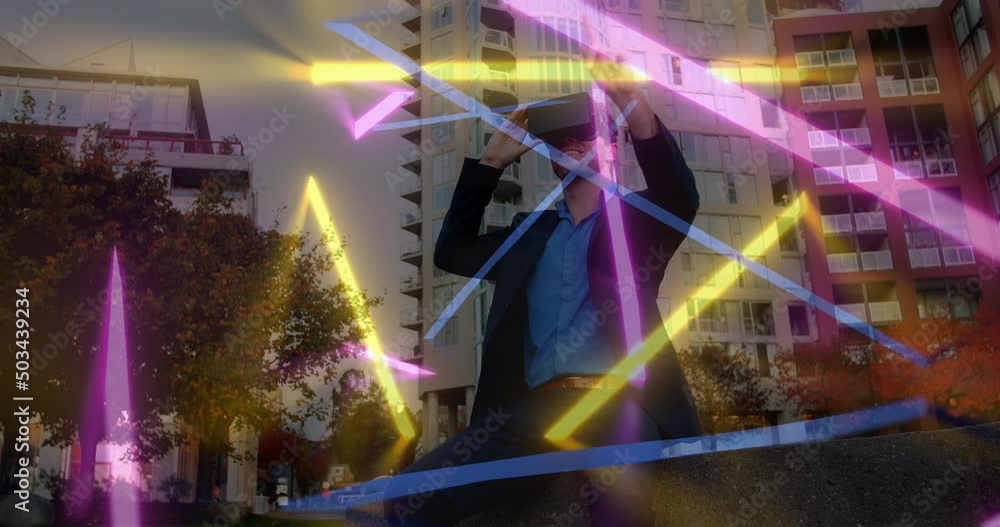 Animation of neon shapes over caucasian man using vr headset Animation of neon shapes over caucasian man using vr headset