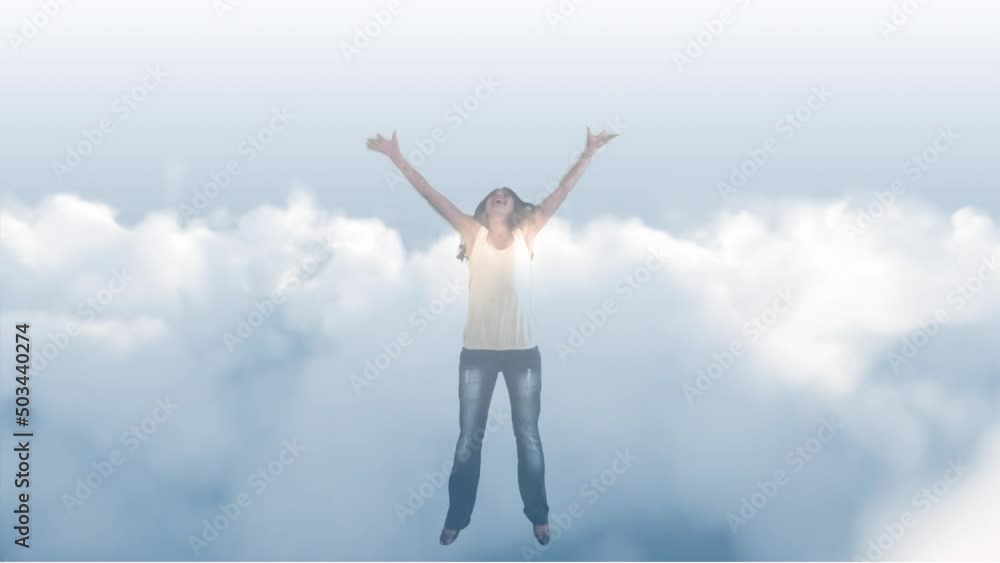 Animation of biracial woman jumping with arms outstretched over sky with clouds Animation of biracial woman jumping with arms outstretched over sky with clouds