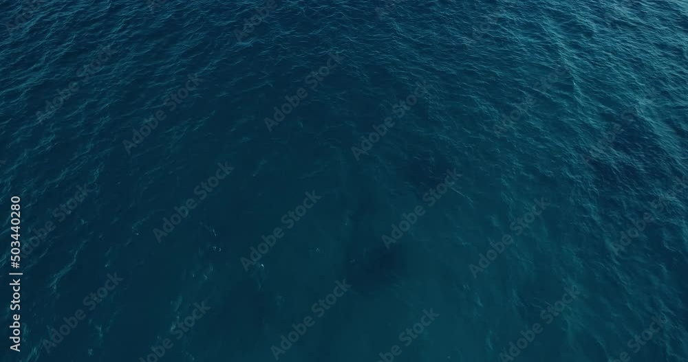 Aerial top down view from high altitude of blue azure turquoise sea water texture. a view of the water surface. Background of the water surface. Aerial top down view from high altitude of blue azure turquoise sea water texture. a view of the water surface. Background of the water surface.