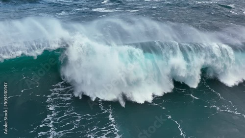 Aerial shot of powerful tsunami wave. Slow motion of big sea or ocean surf wave crashing. UD, 4K. photo