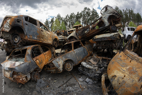 Burned civilian car. Stacked vehicles. War in Ukraine. 