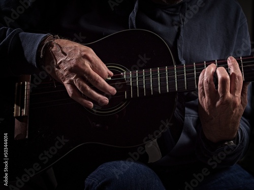Closeup of hands playing a guitar