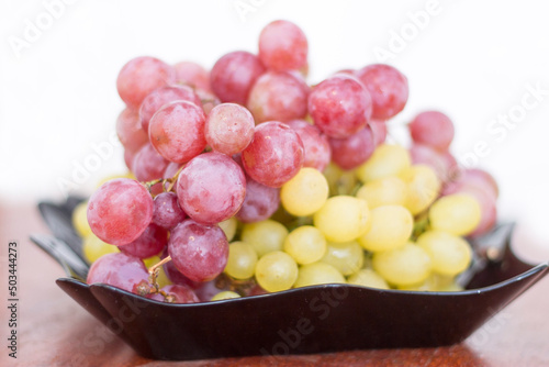 Red and White wine bunch of grapes in the black plate