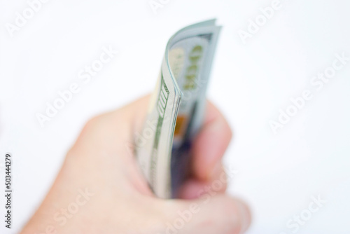 Man ready to exchange pack of Paper Dollars Usa On The White Background
