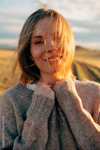 beautiful woman walking on field at sunset