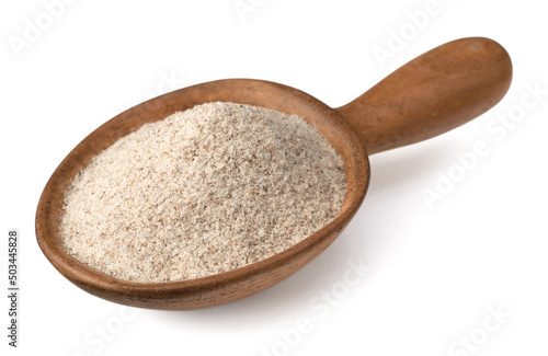 Raw rye flour in the wooden spoon, isolated on white background.