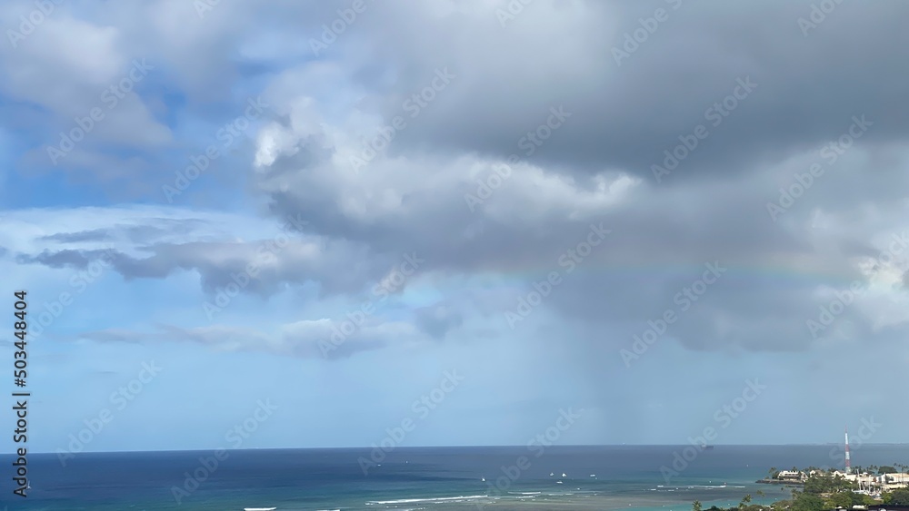 Long rainbow with dramatic clouds over the waikiki beach oahu Island, Hawaii year 2022 Long rainbow with dramatic clouds over the waikiki beach oahu Island, Hawaii year 2022