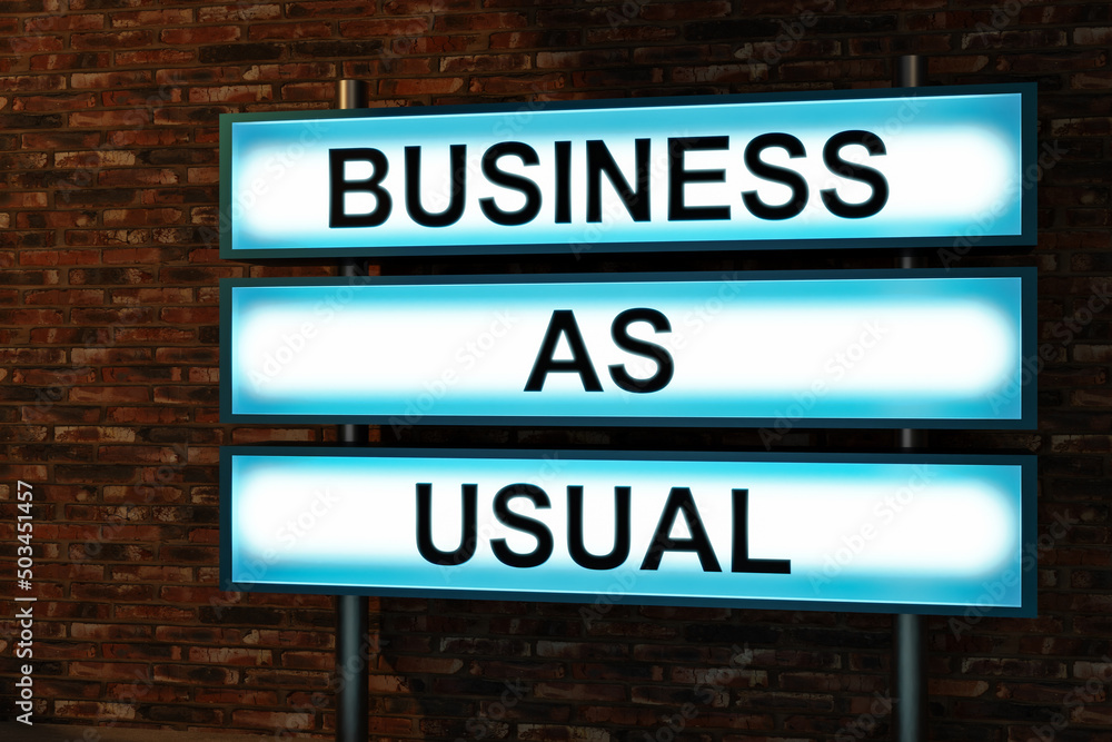 Business as usual. Text in capital letter showed on a light box in front of a red brick wall. Business, routine and inspiration concept. 3D illustration