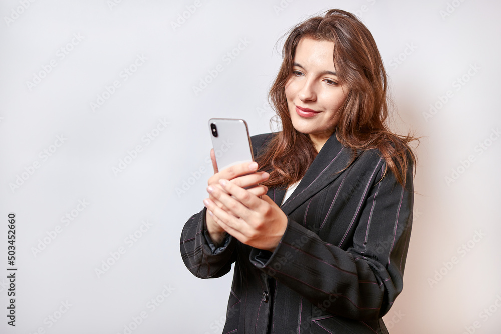 Beautiful businesswoman browsing information on smartphone. Businesswoman concept. Beautiful businesswoman browsing information on smartphone. Businesswoman concept.