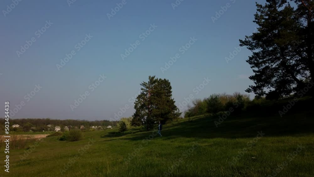 The girl descends from the mountain in a picturesque place The girl descends from the mountain in a picturesque place