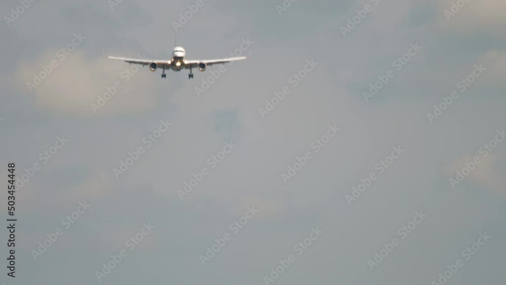 Passenger jet aircraft is descending for landing, haze, long shot. Tourism and travel concept Passenger jet aircraft is descending for landing, haze, long shot. Tourism and travel concept